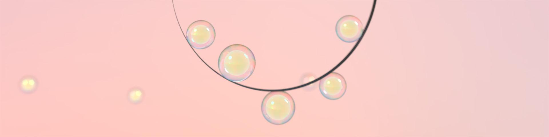  The Hubble Bubble pendant light by Marcel Wanders for Moooi against a pink background.