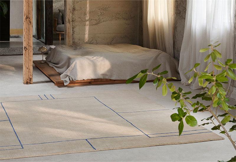  The Cruise rug ﻿by ﻿All the Way to Paris ﻿for ﻿&tradition in Aden Desert Beige in a bedroom.